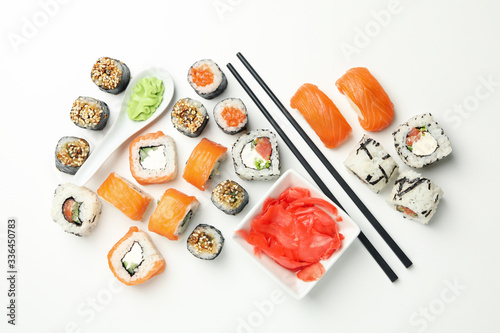 Delicious sushi rolls on white background, top view. Japanese food