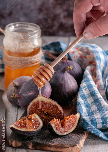 still life of figs with honey on a wooden basis