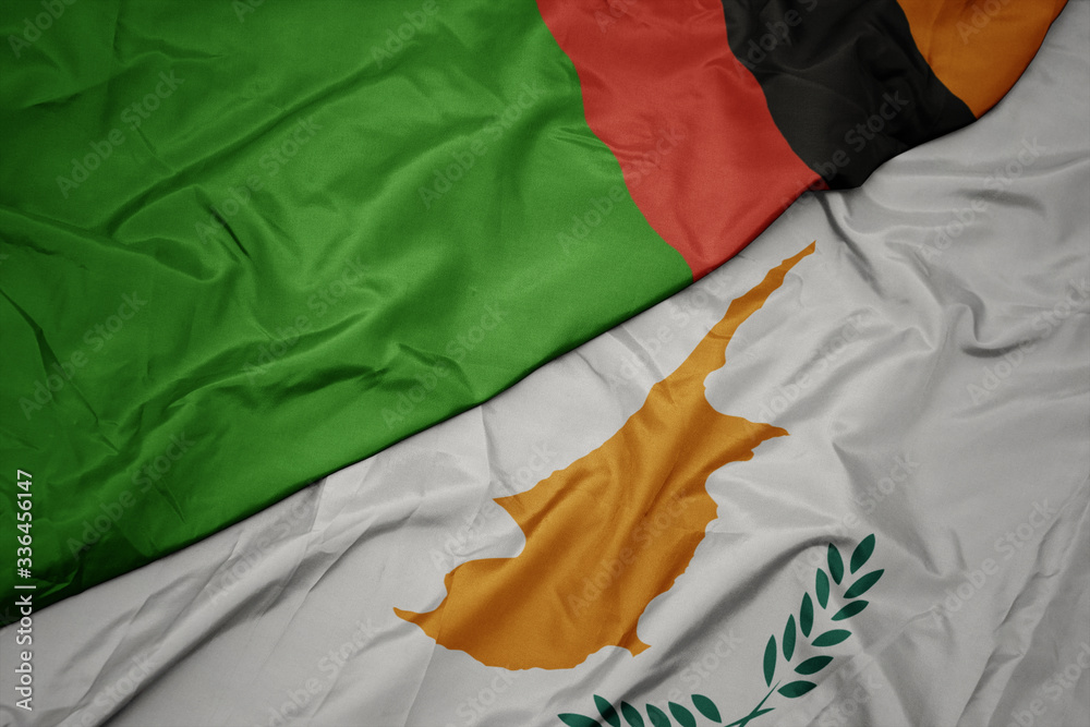 waving colorful flag of cyprus and national flag of zambia.