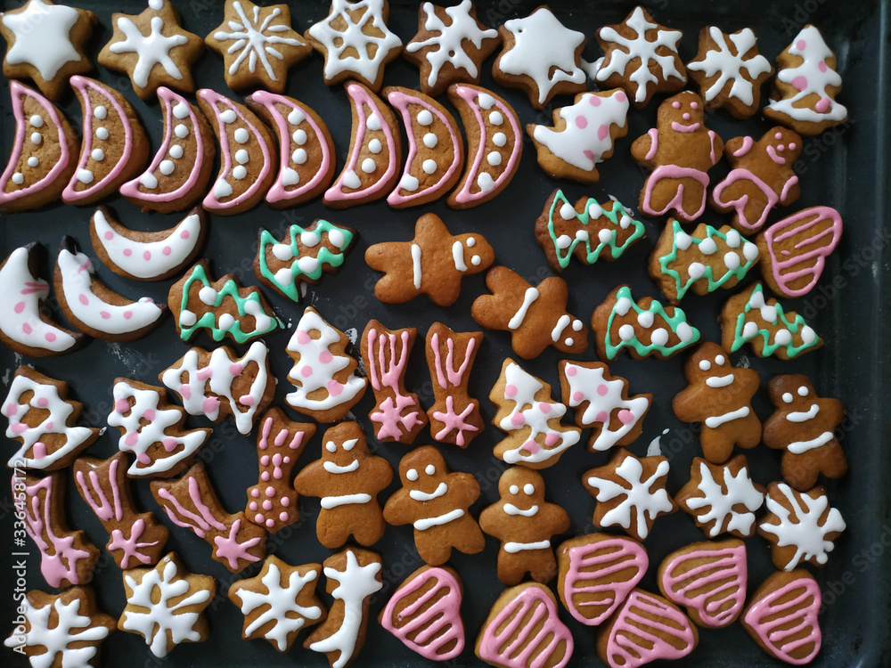 Christmas ginger cookies of different shapes painted with icing sugar