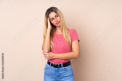 Young Uruguayan woman over isolated background with headache