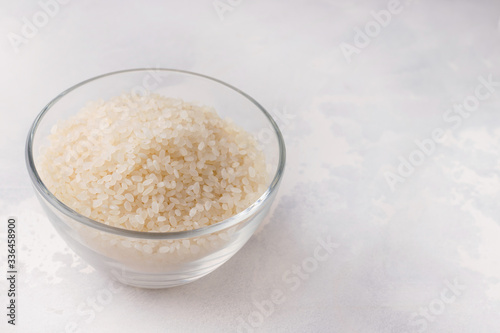 rice in a glass bowl on a white background. copy space