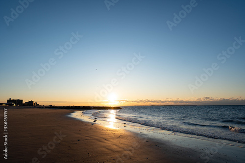 Wallpaper Mural Sunrise over Atlantic Ocean, blue sky, piers. Pier and blue Atlantic Ocean. Red sky sun beams.  Torontodigital.ca