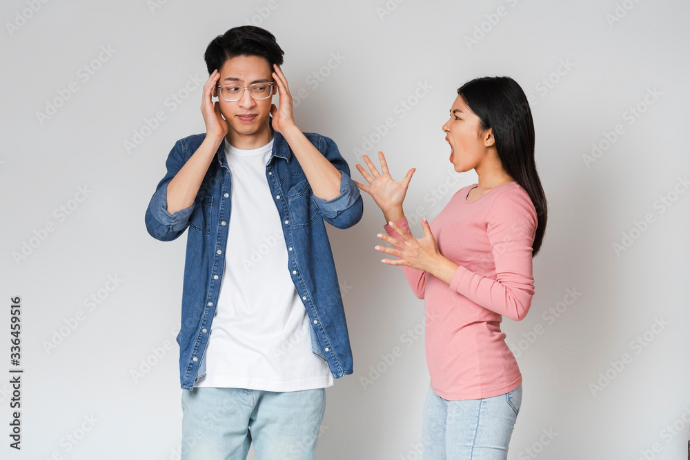Emotional asian girlfriend shouting at her boyfriend Emotional asian girlfriend shouting at her boyfriend