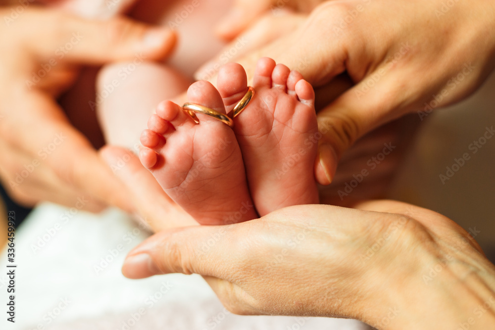 New born fingers with wedding rings 