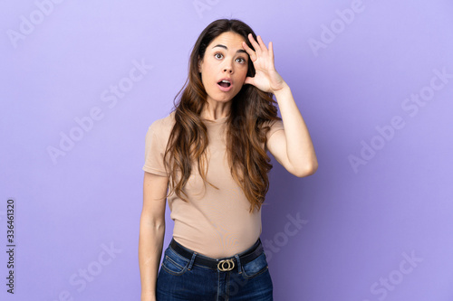 Woman over isolated purple background has realized something and intending the solution