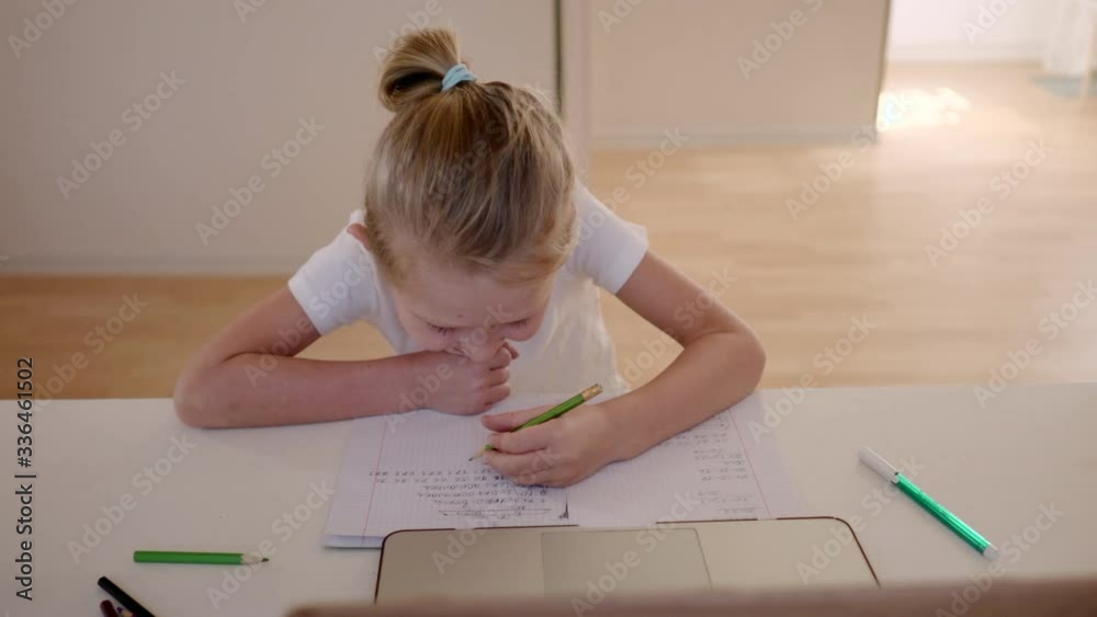 A scene from real life, a smiling boy in lockdown doing homework. A scene from real life, a smiling boy in lockdown doing homework.