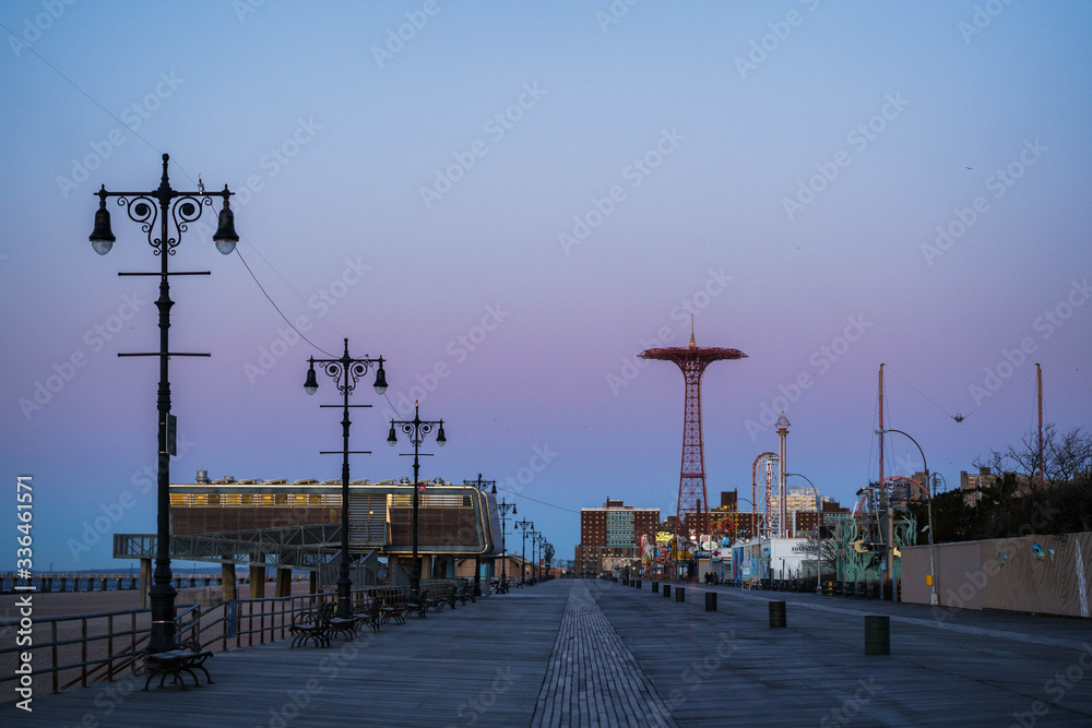 Coney Island attractions at sunrise. Coney Island boardwalk view ...
