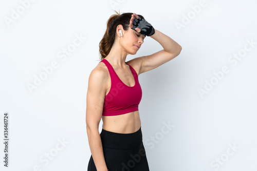 Sport woman over isolated white background with tired expression © luismolinero