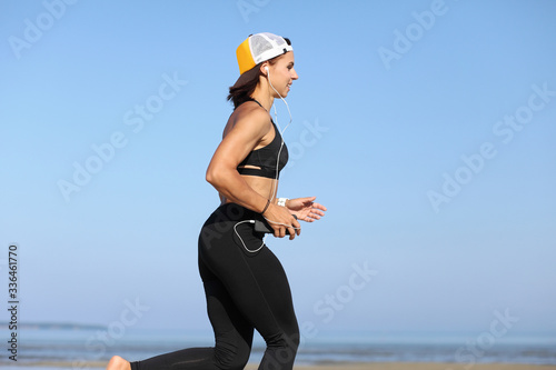 young girl jogging by the sea photo