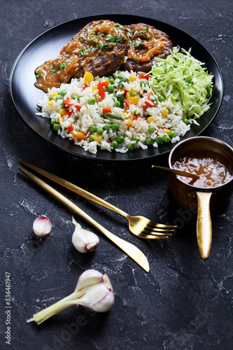 grilled ground beef steaks with salad and rice