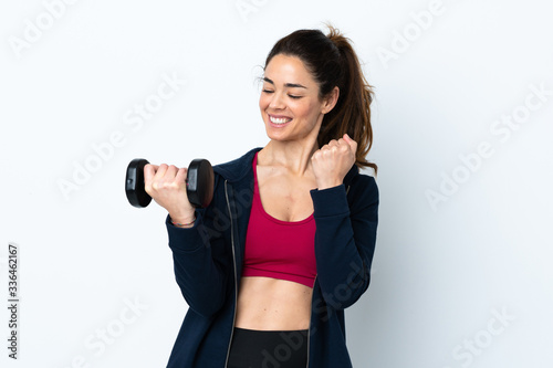 Sport woman making weightlifting over isolated white background celebrating a victory