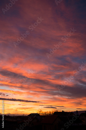 Sunset. Evening sky  clouds are painted in different bright colors  blue  red  orange  purple  pink  yellow.