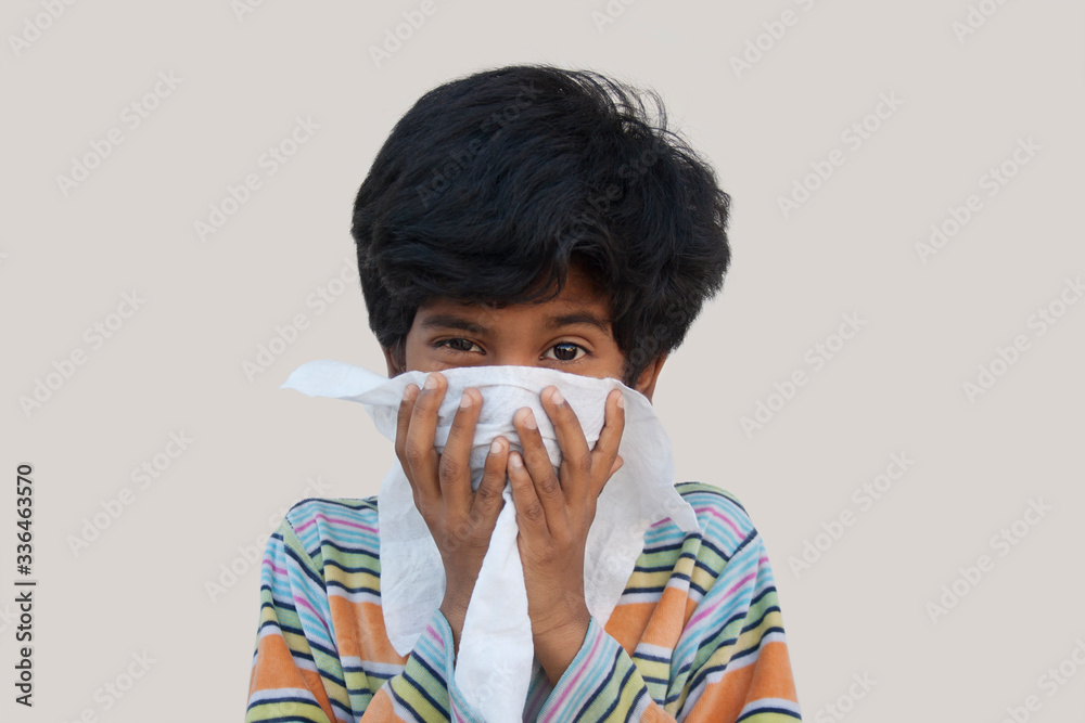 Little Indian boy blowing his nose against Corona virus
Little Indian boy blowing his nose against Corona virus