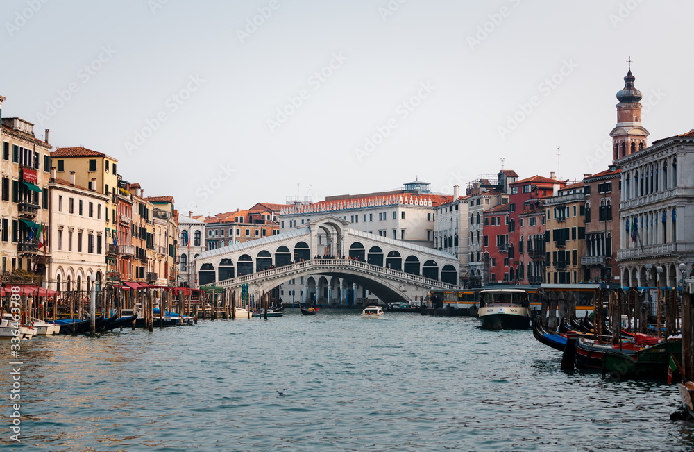 Venice, Italy - February 18, 2020: The Rialto Bridge (Ponte di Rialto), the oldest of the four bridges spanning the Grand Canal in Venice, Italy.
