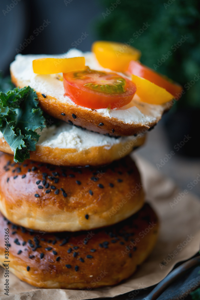 Homemade bagels with cheese and vegetables for brunch on an old wooden background Homemade bagels with cheese and vegetables for brunch on an old wooden background