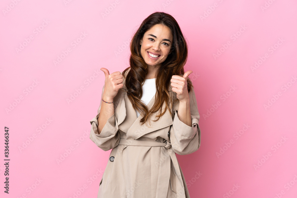 Woman over isolated background with thumbs up gesture and smiling Woman over isolated background with thumbs up gesture and smiling