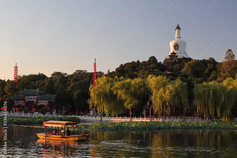 Tranquil lake at sunset time with a pagoda in the background