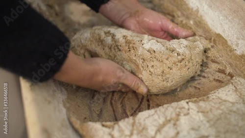 Woman takes bread dough for one bread loaf