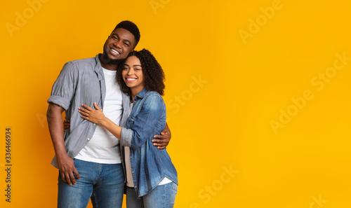 Portrait of happy black couple of lovers embracing each other