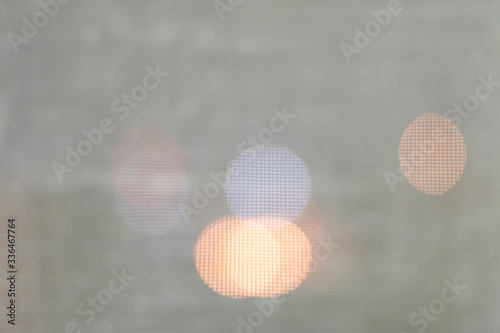 Background blur  bokeh light in the city night light  blur the background blur to see the outside light  focus bokeh. Taken through a mosquito net to see the light