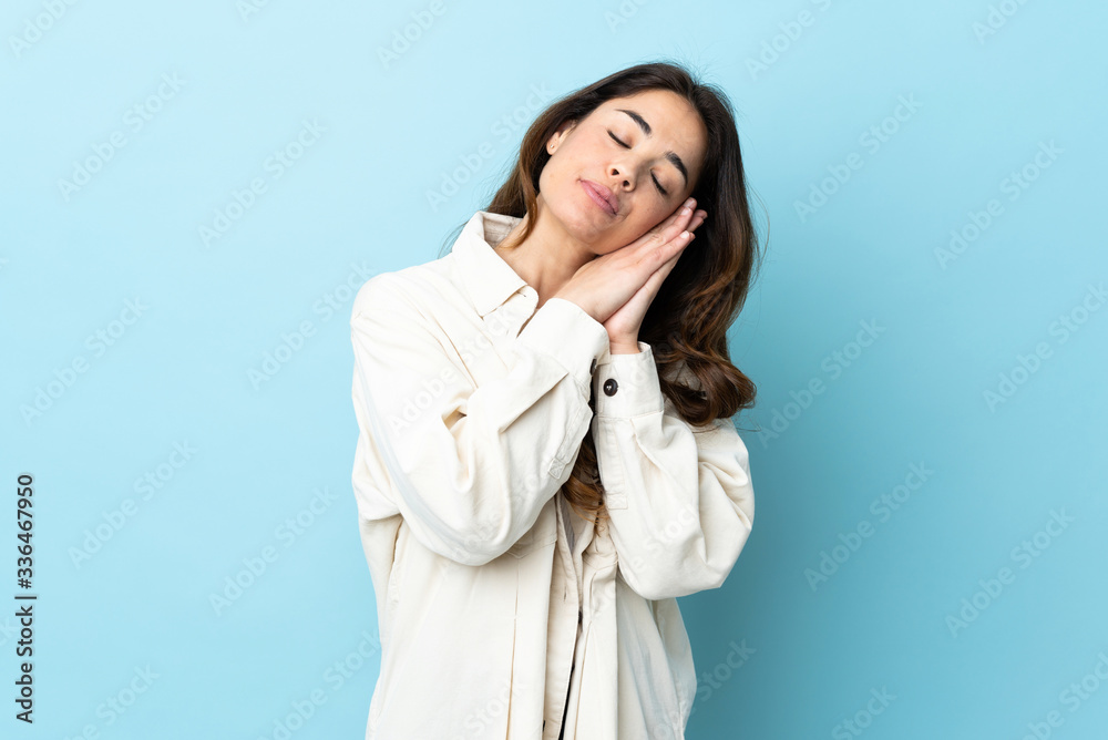 Woman over isolated background making sleep gesture in dorable expression Woman over isolated background making sleep gesture in dorable expression