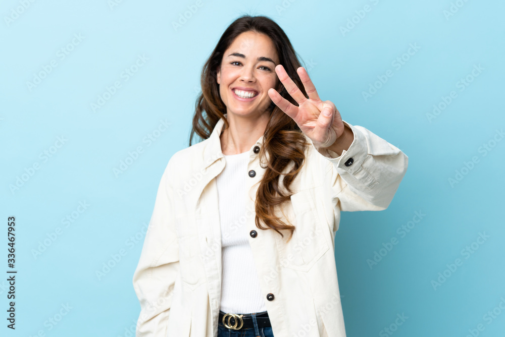 Woman over isolated background happy and counting three with fingers Woman over isolated background happy and counting three with fingers