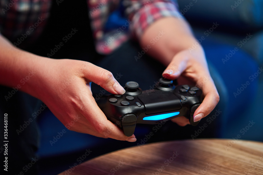 Gamer holding Gamepad, Controller or Videogame Joystick Console in hands. Close up, game concept Gamer holding Gamepad, Controller or Videogame Joystick Console in hands. Close up, game concept