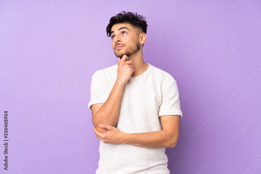 Arabian handsome man over isolated background thinking an idea while looking up Arabian handsome man over isolated background thinking an idea while looking up