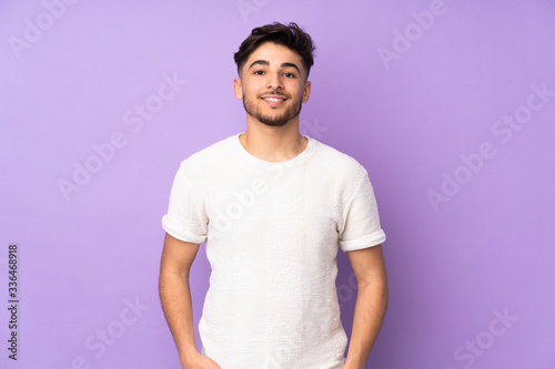 Arabian handsome man over isolated background laughing