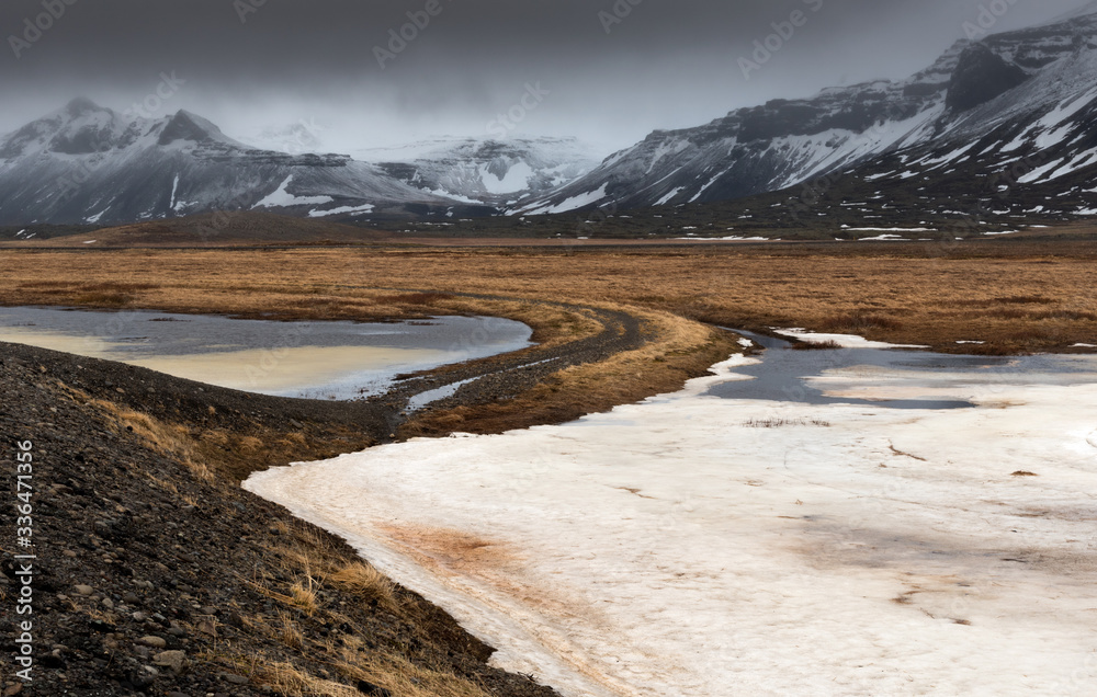 Icelandiclandscape with frozen lake and mountains covered in snow in Iceland Icelandiclandscape with frozen lake and mountains covered in snow in Iceland