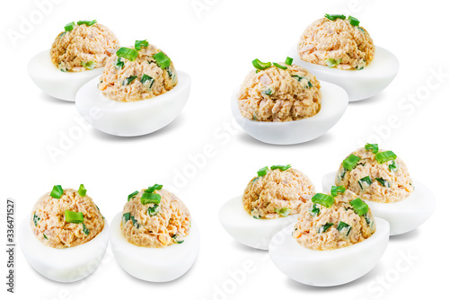Canned Tuna deviled eggs with scallion on a white isolated background