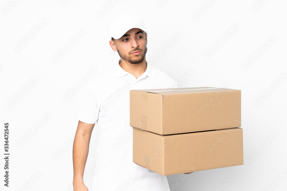 Delivery Arabian man isolated on blue background thinking an idea Delivery Arabian man isolated on blue background thinking an idea