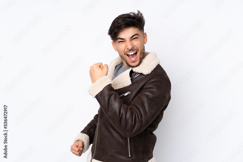 Arabian handsome man over isolated background celebrating a victory Arabian handsome man over isolated background celebrating a victory