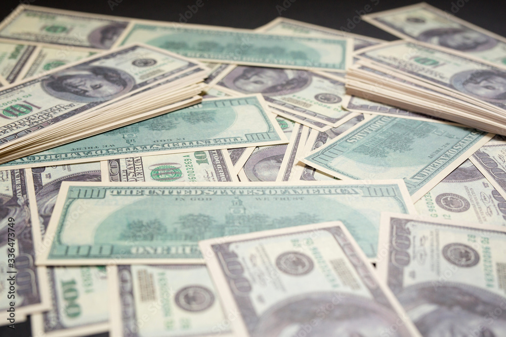 several dollar bills lying on a black background several dollar bills lying on a black background
