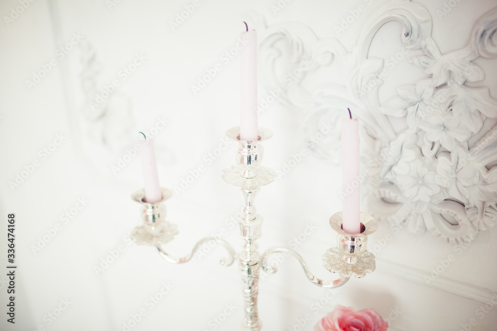 Many candles with candlesticks on the home background. Home and home decor. Many candles with candlesticks on the home background. Home and home decor.
