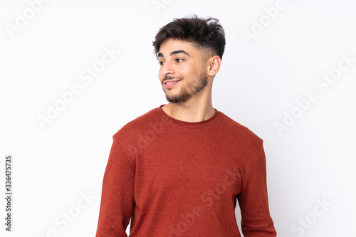 Arabian handsome man over isolated background looking to the side and smiling