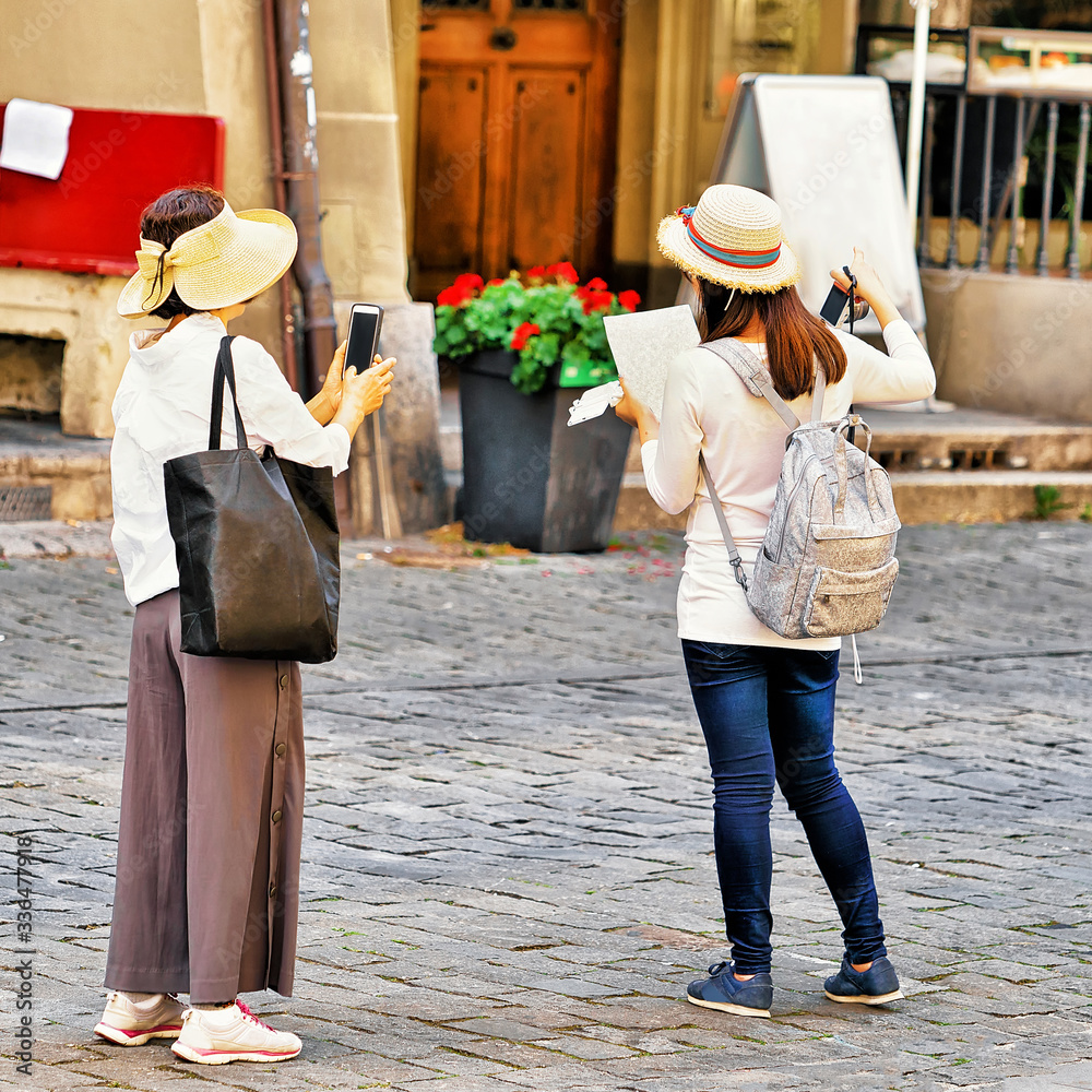 Asian women tourists in Kramgasse street in Bern Asian women tourists in Kramgasse street in Bern