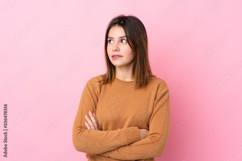 Young woman over isolated pink background with confuse face expression Young woman over isolated pink background with confuse face expression