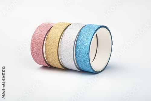 Four rolls of glitter tape on a white background photo