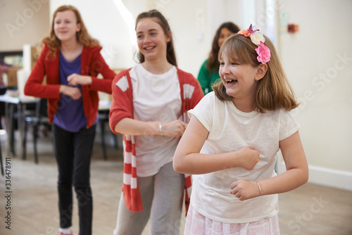 Group Of Children Enjoying Dance Lesson At Stage School Together