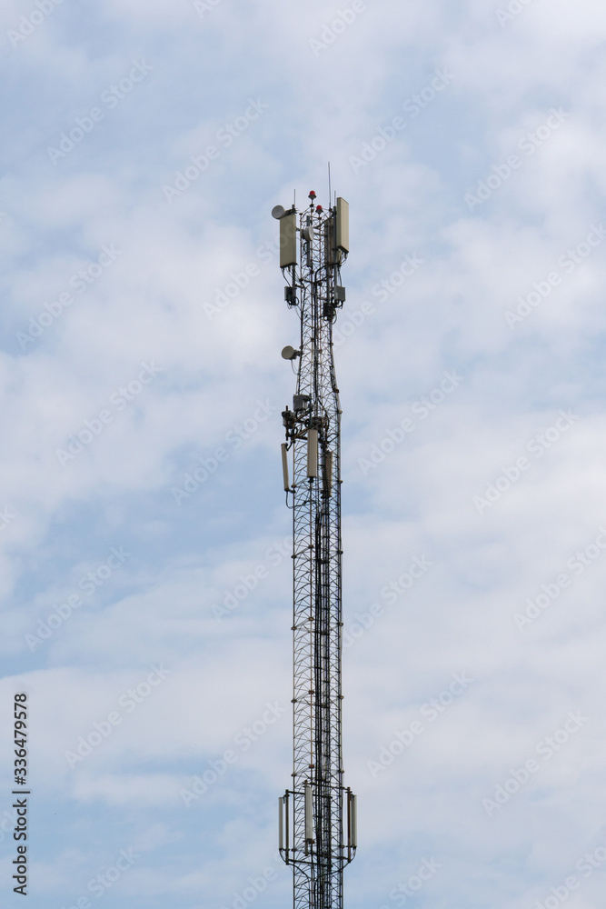 Telecommunication 5g toower on blue cloudy sky background