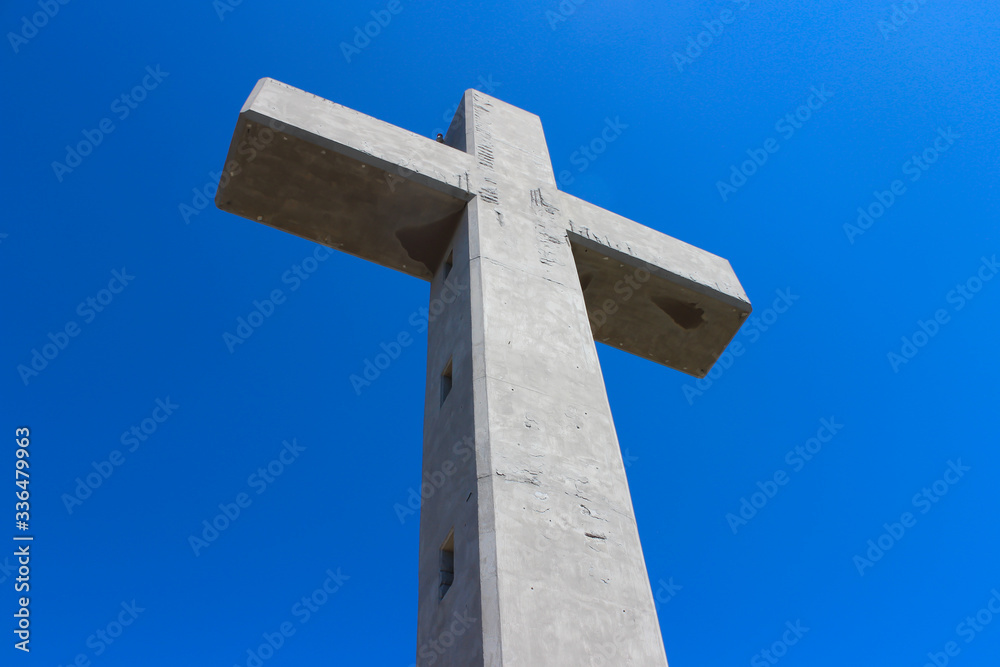 Large cross monument in Filerimos, Rhodes island, Greece on the blue sky background.