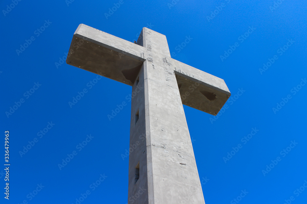 Large cross monument in Filerimos, Rhodes island, Greece on the blue sky background. Large cross monument in Filerimos, Rhodes island, Greece on the blue sky background.