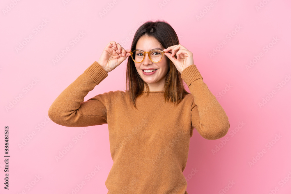 Young woman over isolated pink background with glasses and surprised Young woman over isolated pink background with glasses and surprised