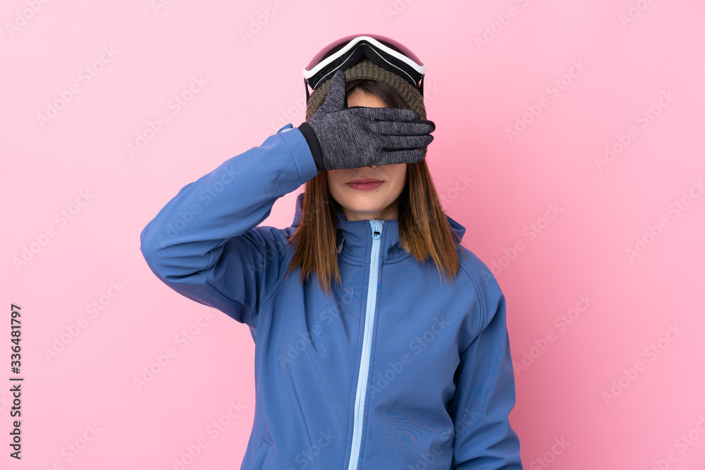 Young skier woman over isolated pink background covering eyes by hands Young skier woman over isolated pink background covering eyes by hands