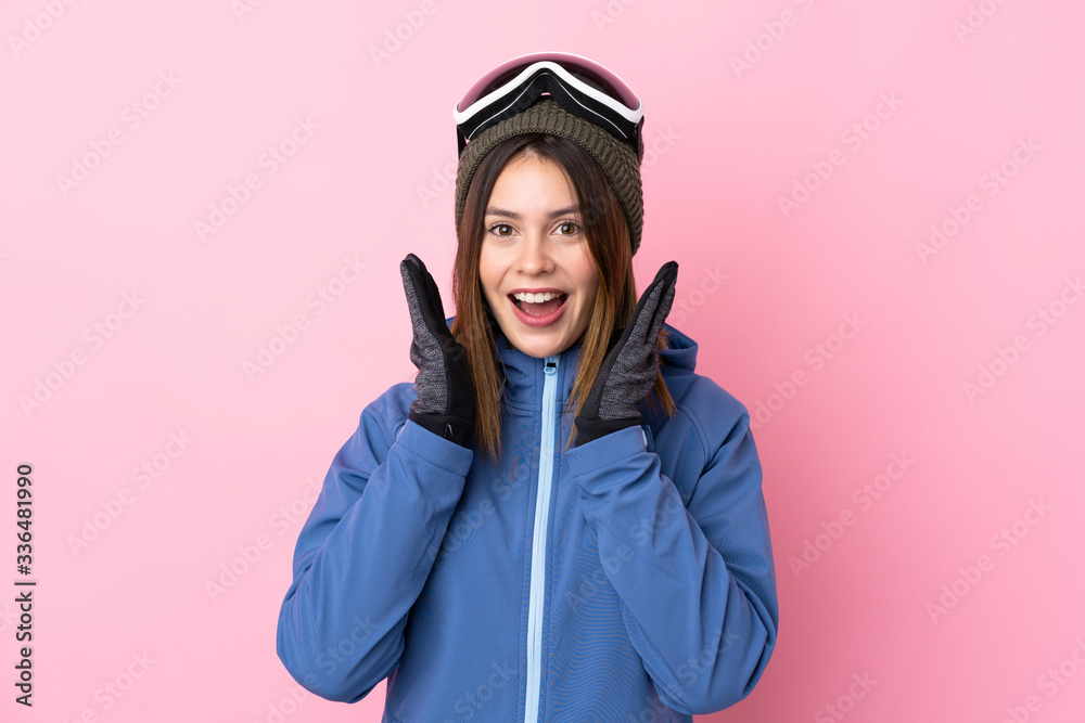 Young skier woman over isolated pink background with surprise facial expression Young skier woman over isolated pink background with surprise facial expression
