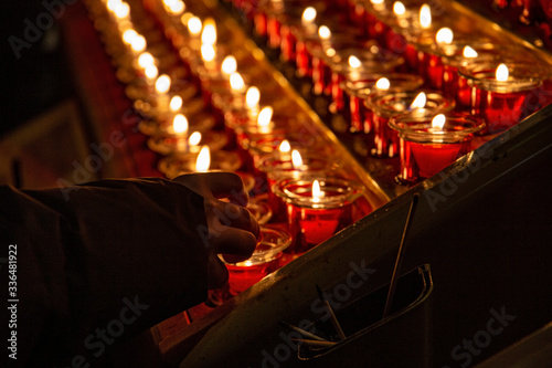 Candlesticks with small lit candles in church