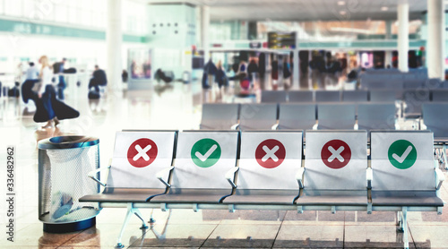 a row of empty chairs with an indication of where it is possible to sit to maintain the social safety distance during the period of the COVID-19 coronavirus pandemic photo