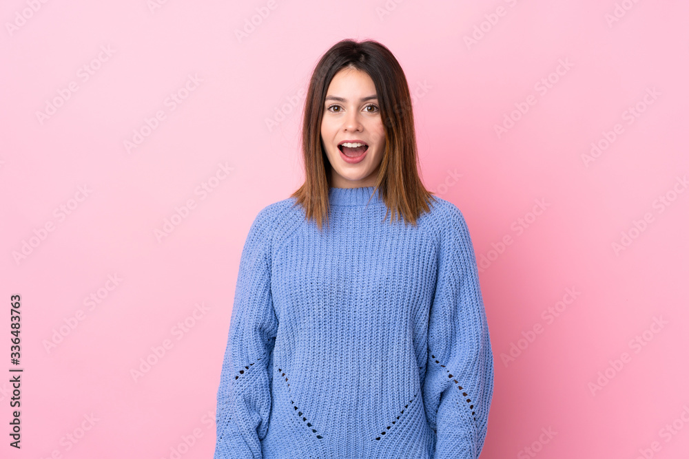 Young woman with blue sweater over isolated pink background with surprise facial expression Young woman with blue sweater over isolated pink background with surprise facial expression